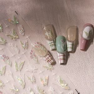 Iridescent laser nail stickers featuring butterfly and tulip designs with star elements