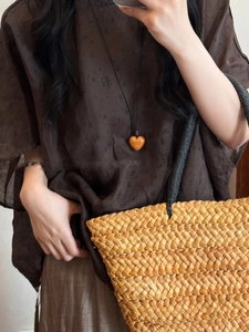 Detail of wooden heart pendant and brown wax rope necklace with vintage aesthetic