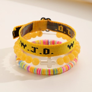 Stacked three-piece bracelet set featuring WWJD fabric, cross beads and rainbow clay discs