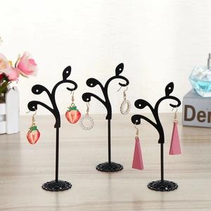 Three-piece black tree-shaped metal earring stands with round hooks and circular bases