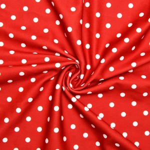 Detail of soft red polka dot fabric texture with elastic drape for elegant dress