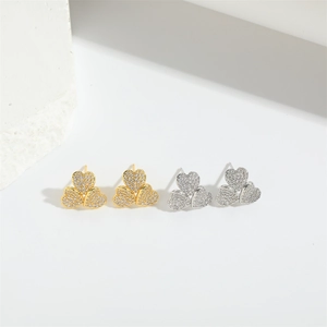 Detail of heart stud earring set with gold and silver plating and micro-pave zircons