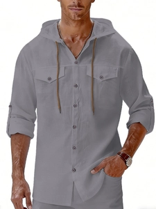 Detail of light grey linen hooded shirt with front pockets and wooden buttons