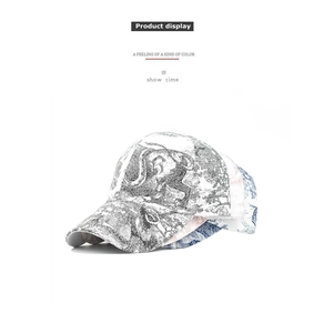 Detail of stacked baseball caps with vintage blue and pink toile de jouy pattern