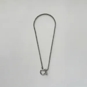 Close-up of silver stainless steel wheat chain with unique horseshoe shackle clasp