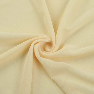 Close-up of light beige mesh fabric detail showing delicate texture and layers