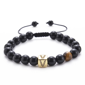 Detail view of black agate bracelet with tiger eye stone and micro-pave letter V charm