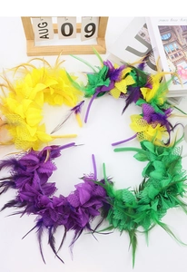 Flat lay of colorful feather and lace floral headbands for carnival and festive parties