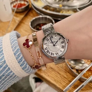 Classic silver steel watch with Roman dial paired with clover and crystal bracelets