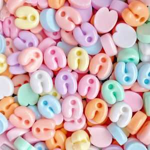 Macro shot of colorful U-shaped resin beads for DIY jewelry and phone case crafts