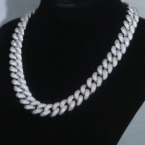 Close-up of 15mm silver Cuban chain with sparkling diamonds on black velvet stand
