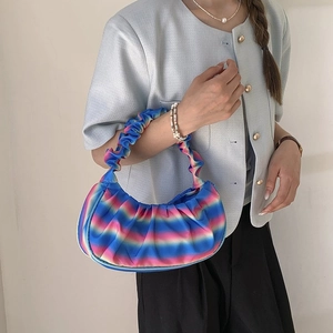 Macro detail of rainbow gradient pleated shoulder bag featuring soft cloud-like texture