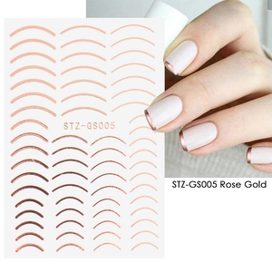 Detail of rose gold curved nail stickers for French manicure with metallic luster finish