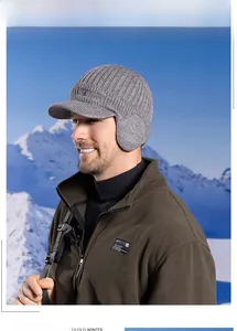 Close-up of grey winter knitted earflap hat with visor and Sport embroidery detail