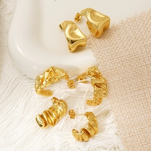 Three pairs of irregular gold C-shaped earrings with pleated and liquid metal texture