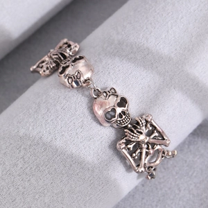 Gothic punk skull and crossbones bracelet in vintage silver finish on display stand