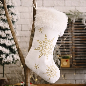 White velvet Christmas stocking with gold snowflake embroidery and pearl accents
