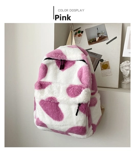 Detailed view of plush pink and white cow print backpack with soft faux fur texture
