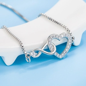 Elegant silver heart and infinity necklace with white zircon pavé on a box chain