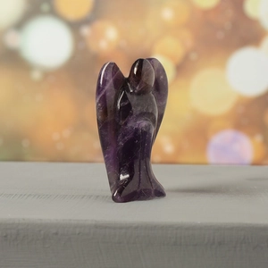 Macro shot of 1.5-inch purple amethyst angel figurine with natural mineral texture