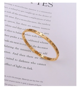 Macro view of gold plated titanium steel bangle with Roman numerals and crystals