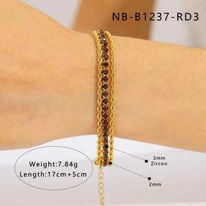 Detailed view of layered gold braided rope bracelet with 3mm dark red zircon accents