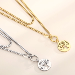 Detailed view of gold and silver double-layered necklaces with Tree of Life charms