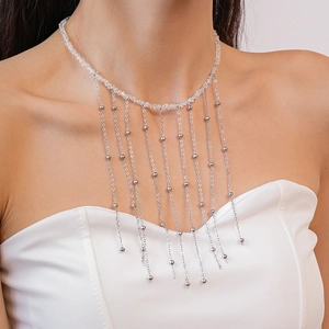 Detailed view of silver layered fringe necklace with transparent crystal beads and metal tassels