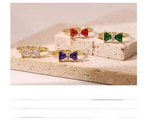 Detailed macro view of bow ring featuring colorful crystals and 18k gold vacuum plating