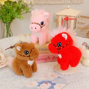 Three plush pony keychains in red pink and brown colors with fluffy texture and hooks