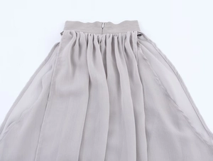 Close-up of elegant grey pleated waistline featuring a seamless invisible zipper closure