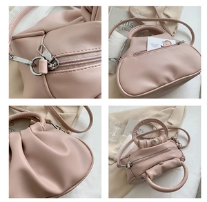 Detail view of the pink cloud bag showing zipper hardware, pleated texture and pocket