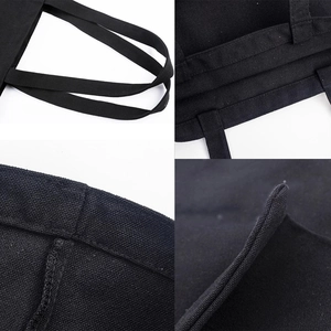 Black canvas tote bag with cute dog design showing durable stitching and fabric detail