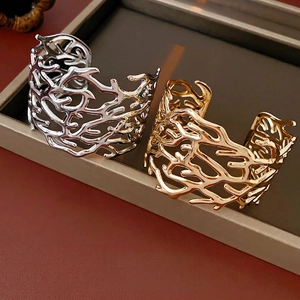 Artistic cutout open cuff bracelet with coral branch texture in gold and silver finish