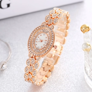 Detailed macro view of a rose gold quartz watch with a crystal-encrusted oval dial case