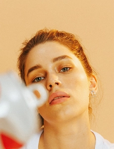 Close-up of stylish silver can tab earring worn by a model in a fashion setting
