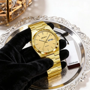 Close-up of gold stainless steel men's watch featuring a day-date display dial