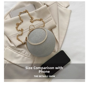 Macro shot of grey spherical evening bag with rhinestone trim and golden handle
