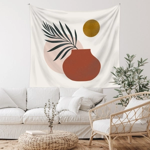 Modern Bohemian tapestry detail with abstract vase and palm leaf in a warm living room