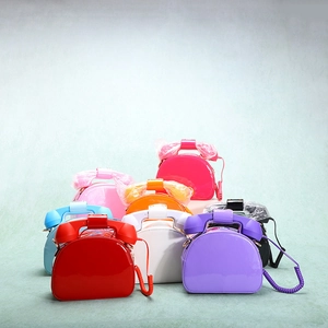 Detailed stack of novelty telephone shaped handbags in colorful glossy patent leather finishes