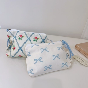 Floral and gingham fabric pouches with light blue rope handles and zipper closure