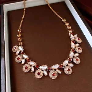 Detail of vintage flower necklace with red rhinestones in a brown jewelry gift box