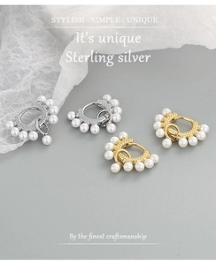 Detail shot of gold and silver S925 sterling silver hoop earrings with white pearls