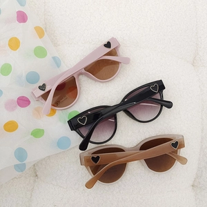 Stylish cat-eye kids sunglasses with gold heart detail in pink, black and amber colors