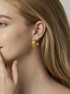 Close-up of gold 18k plated triple-layered wrinkled texture C-shaped hoop earrings