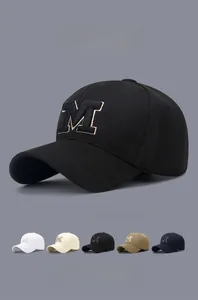 Detail view of M embroidery on baseball cap showing multi-color swatch selection