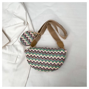Detail of woven crossbody bag set with wavy green and pink patterns and round coin purse