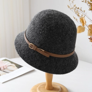 Detail of dark grey wool cloche hat with a brown leather belt and gold buckle accent