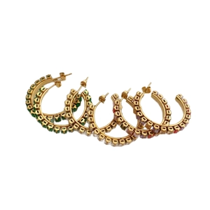 Set of five gold stainless steel hoop earrings with colorful zircon gemstones on white background