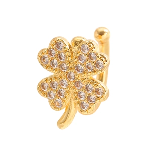 Detail of clover-shaped gold earring cuff with zircon stones on white background